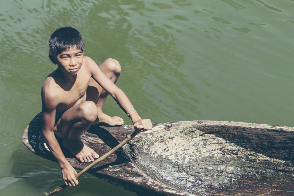 A boy paddling his wooden banca at Lake Sebu, North Cotabato.