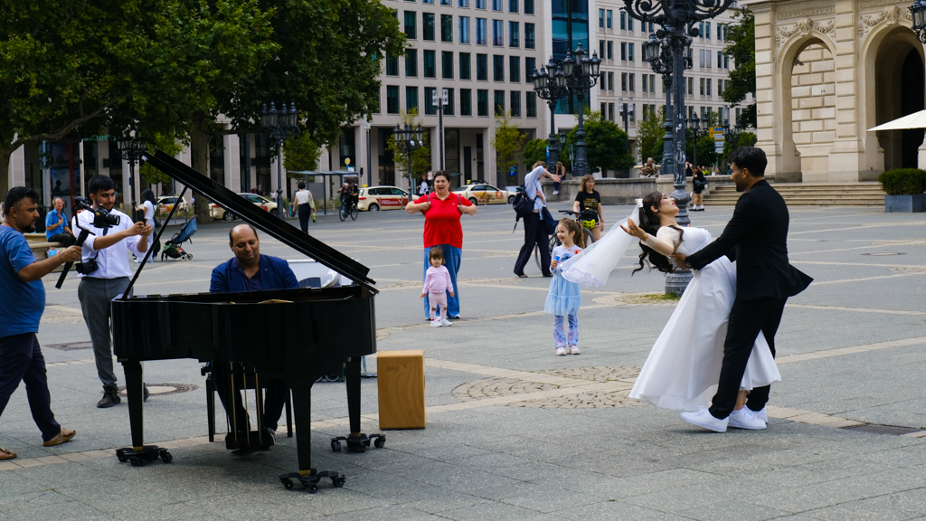 This street musician plays a wonderful song for the newly wed